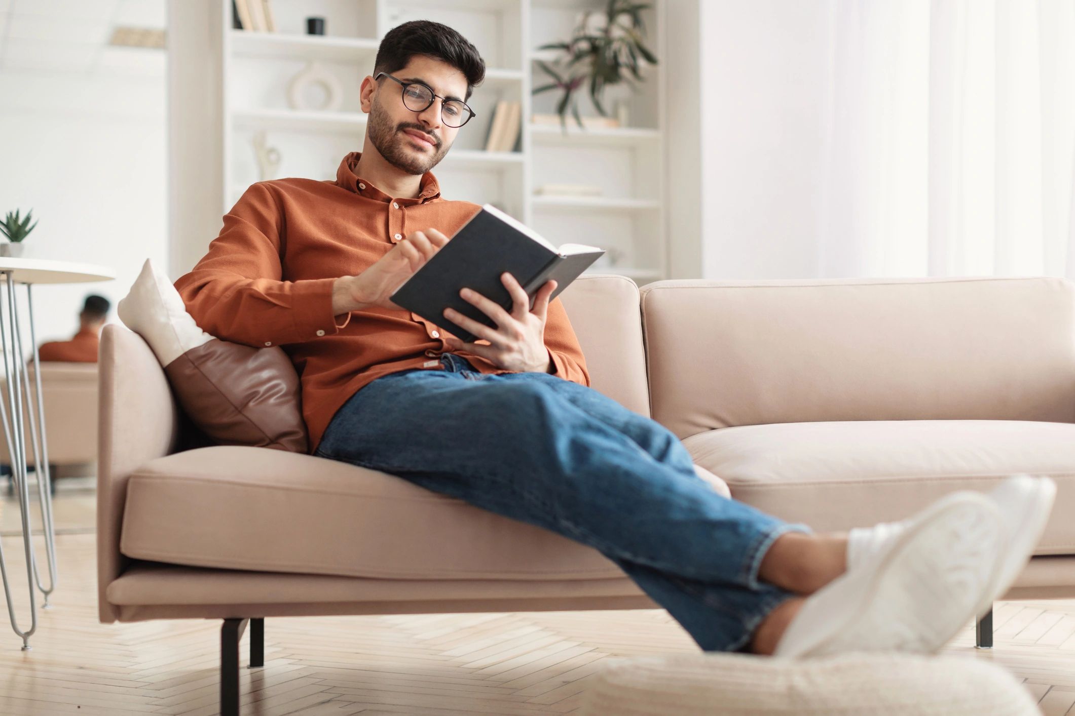 Customer portrait reading a book at home