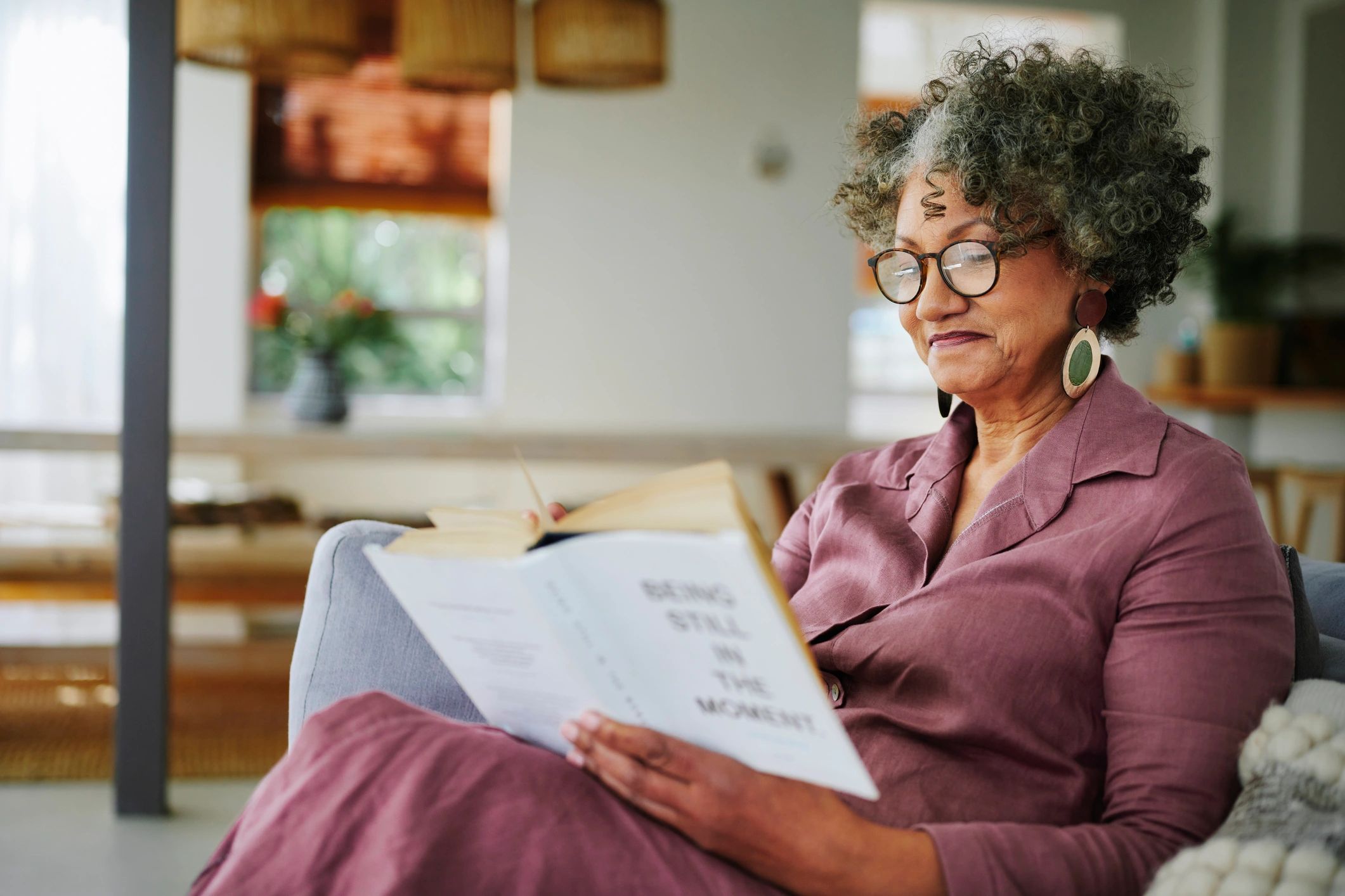 Reader relaxing with a book at home