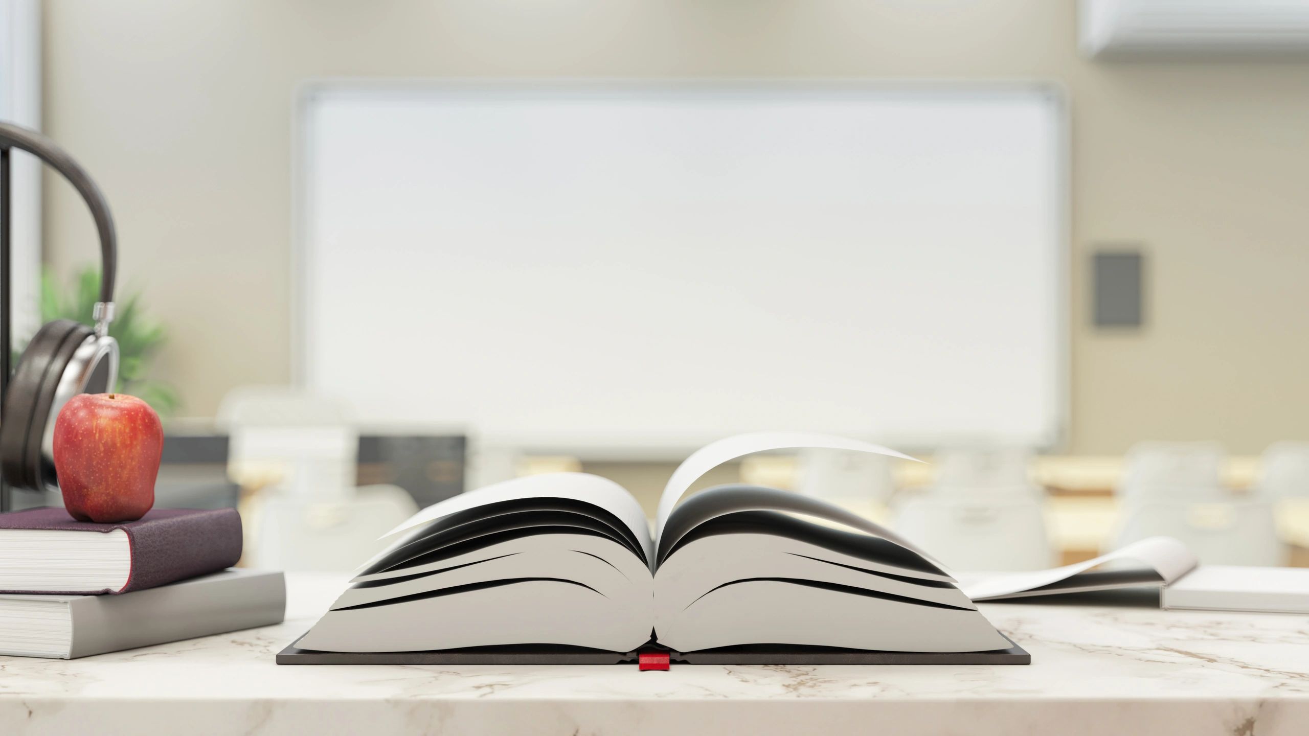 Open book on a desk with a softly blurred background
